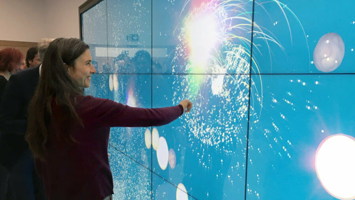 woman interacting with media wall